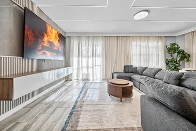 a living room with a couch and a tv at Brand NEW 05 Bedrooms4 Baths At Storey Lake in Kissimmee