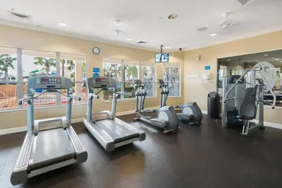 a gym with several treadmills and elliptical machines at NEW - Paradise townhome at Windsor Hills in Orlando