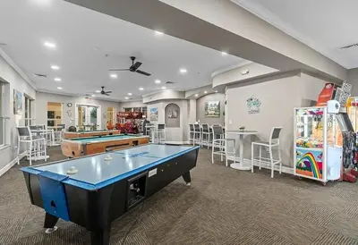 a room with a ping pong table and a pool at NEW - Paradise townhome at Windsor Hills in Orlando