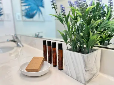 a bathroom counter with a vase with a plant in it at Enchanted Escape-Perfect Pool to Relax & Recharge in Kissimmee