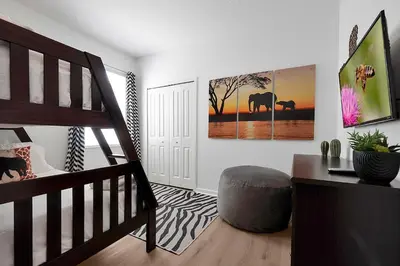 a bedroom with a bunk bed and a bedroom with a ladder at Enchanted Escape-Perfect Pool to Relax & Recharge in Kissimmee