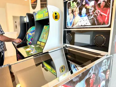 a man standing in front of a video game at Enchanted Escape-Perfect Pool to Relax & Recharge in Kissimmee
