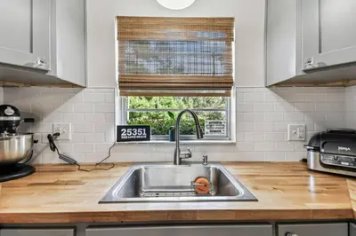 a kitchen counter with a sink and a window at Relaxing Modern Home Sleeps 6 Pool BBQ Firepit in Sorrento