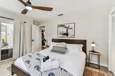 a bedroom with a bed and a ceiling fan at Relaxing Modern Home Sleeps 6 Pool BBQ Firepit in Sorrento