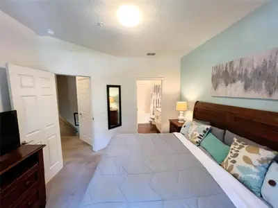 a bedroom with a large bed and a television at 4 Bedrooms 3 Bathrooms Lucaya 10-108 in Kissimmee