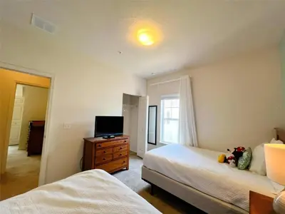 a bedroom with two beds and a flat screen tv at 4 Bedrooms 3 Bathrooms Lucaya 10-108 in Kissimmee