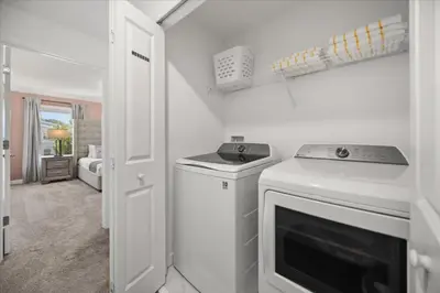 a white kitchen with a stove and a dishwasher at 4 Bedrooms 3 Bathrooms Storey Lake 2952 Ps in Kissimmee