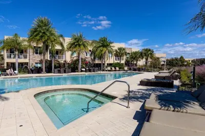 a swimming pool at a resort with palm trees at 4 Bedrooms 45 Bathrooms Magic Village7603Rd in Orlando