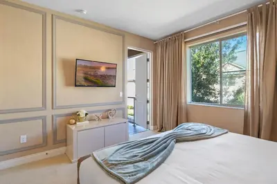 a bedroom with a large bed and a window at 4 Bedrooms 45 Bathrooms Magic Village7603Rd in Orlando