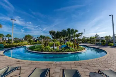 a pool at a resort with palm trees at 2 Bedrooms 2 Bathrooms Storey Lake 3151-404 in Kissimmee