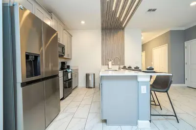 a kitchen with a stainless steel refrigerator and a counter at Private Pool - Themed Rooms - Near Disney 4239 in Kissimmee