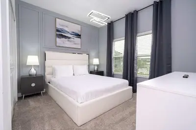 a bedroom with a white bed and two windows at Private Pool - Themed Rooms - Near Disney 4239 in Kissimmee