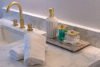 a bathroom counter with a towel and a sink at Spacious Modern Japandi Retreat - Winter Park in Orlando