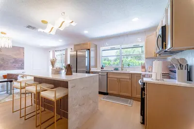 a kitchen with a large island with a counter top at Spacious Modern Japandi Retreat - Winter Park in Orlando