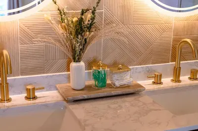 a bathroom with a sink and a vase with flowers at Spacious Modern Japandi Retreat - Winter Park in Orlando