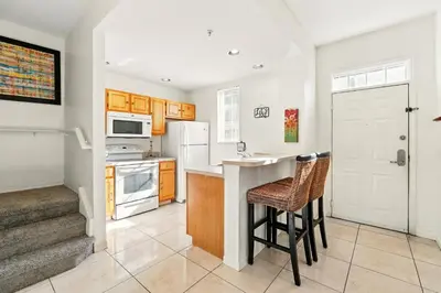 a kitchen with a counter and some stools in it at Your Orlando Escape - Gated Resort with Amenities in Kissimmee