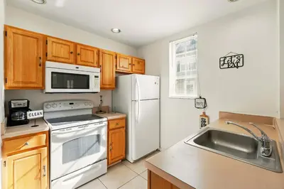 a kitchen with a white refrigerator and a sink at Your Orlando Escape - Gated Resort with Amenities in Kissimmee