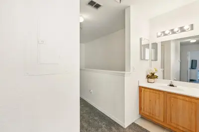 a bathroom with a sink and a mirror at Your Orlando Escape - Gated Resort with Amenities in Kissimmee