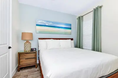 a bedroom with a bed and a window at Paradise Breeze Cottage By Shine Villas Margaritaville Resort Orlando in Orlando