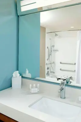 a bathroom with a sink and a mirror at Courtyard by Marriott Orlando Lake Nona in Orlando