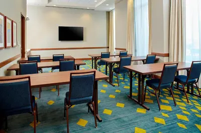 a conference room with tables and chairs and yellow sticky notes on the floor at Residence Inn by Marriott Orlando Lake Nona in Orlando