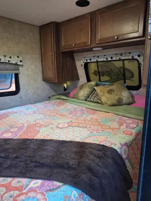 a bedroom with a bed in an rv at Tiny Trailer happy hole in the wall in Orlando