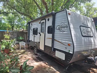 an rv is parked in a yard at Tiny Trailer happy hole in the wall in Orlando