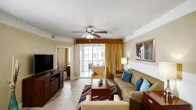 a living room with a couch and a flat screen tv at Calypso Cay Vacation Villas in Kissimmee