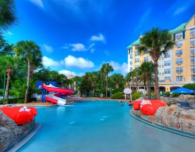 a pool at a resort with a water slide at Calypso Cay Vacation Villas in Kissimmee