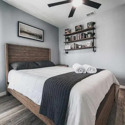 a bedroom with a large bed with two towels on it at 3BD Townhome with Pool 12mi to Disney and Universal in Kissimmee