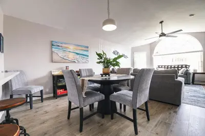 a living room with a table and chairs and a couch at 3BD Townhome with Pool 12mi to Disney and Universal in Kissimmee