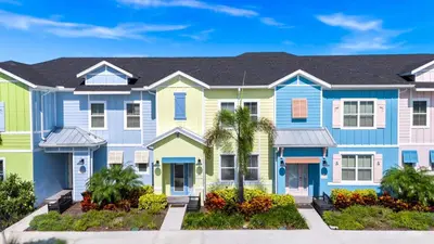 a row of houses with blue and yellow at Bright And Beachy Villa Near Disney With Margaritaville Resort And Island H20 Waterpark Access - 3012Cs in Orlando