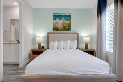 a bedroom with a large white bed and two lamps at Bright And Beachy Villa Near Disney With Margaritaville Resort And Island H20 Waterpark Access - 3012Cs in Orlando
