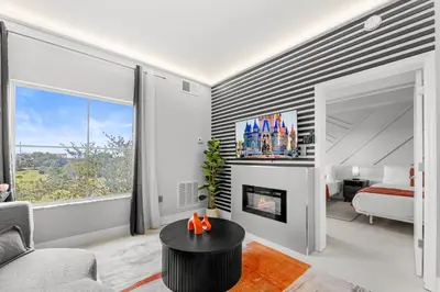a living room with a fireplace and a bedroom at 1BR Suite Prime Orlando Location in Orlando