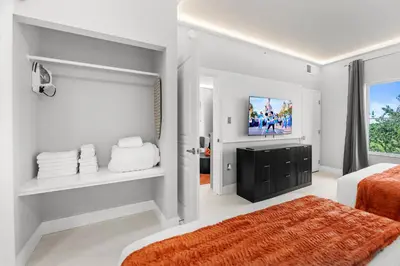 a bedroom with a bed and a tv on a wall at 1BR Suite Prime Orlando Location in Orlando
