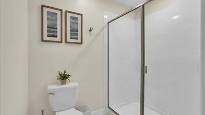 a bathroom with a toilet and a glass shower at Parfect Paradise in Orlando