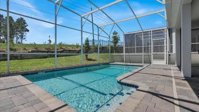a swimming pool in a house with a glass wall at Parfect Paradise in Orlando
