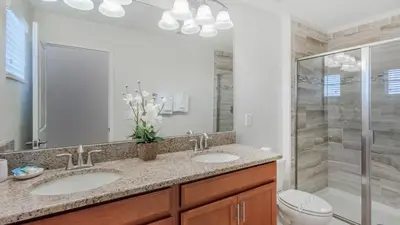 a bathroom with two sinks and a shower at Storey Lake Villa in Kissimmee