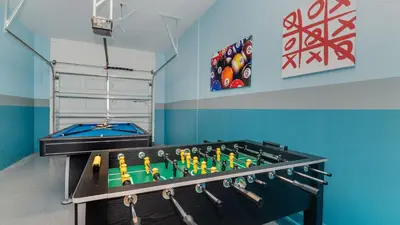 a room with a ping pong table and a pool table at Storey Lake Retreat in Kissimmee
