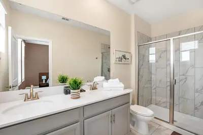 a bathroom with a sink and a toilet and a shower at Winterfield storeylake 2759 in Kissimmee