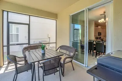 a dining room with a table and chairs and a balcony at Winterfield storeylake 2759 in Kissimmee