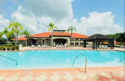 a large swimming pool in front of a building at Resort 4 Br 3 Ba Private Pool Home & Lake View near Disney & Universal in Kissimmee