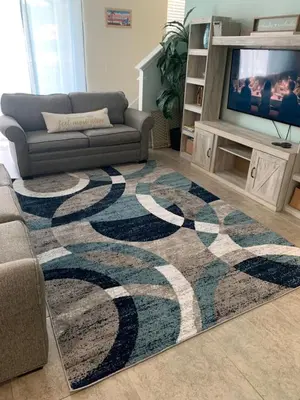 a living room with a couch and a rug at Resort 4 Br 3 Ba Private Pool Home & Lake View near Disney & Universal in Kissimmee