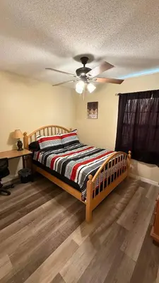 a bedroom with a bed and a ceiling fan at G7 Private Room with Smart TV Near Everything in Orlando