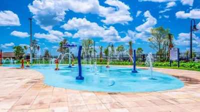 a playground with water fountains in a park at The Sunshine Villa in Kissimmee