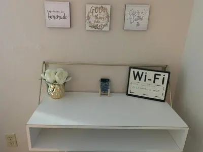 a white shelf with a vase of flowers on it at Aqua Condo-Free Shuttle-Disney-Universal EPIC in Orlando