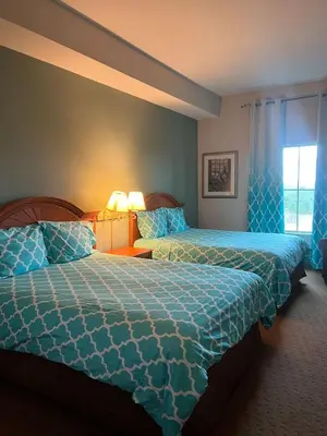 a hotel room with two beds and a window at Condo near Disney-free shuttle to all theme parks in Orlando
