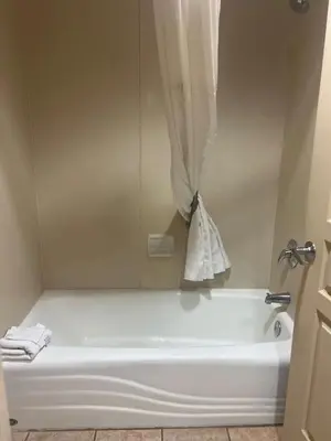 a bathroom with a bath tub with a shower curtain at Condo near Disney-free shuttle to all theme parks in Orlando