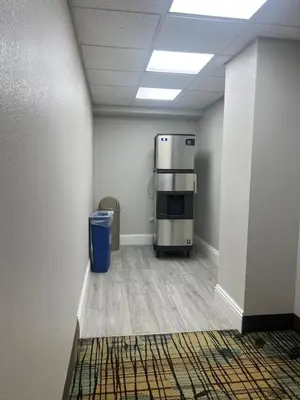 an office room with a refrigerator and a trash can at Condo near Disney-free shuttle to all theme parks in Orlando
