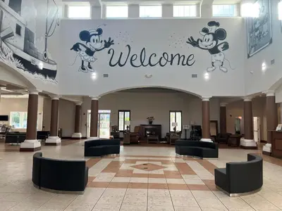 a lobby with a welcome sign on the wall at Condo near Disney-free shuttle to all theme parks in Orlando